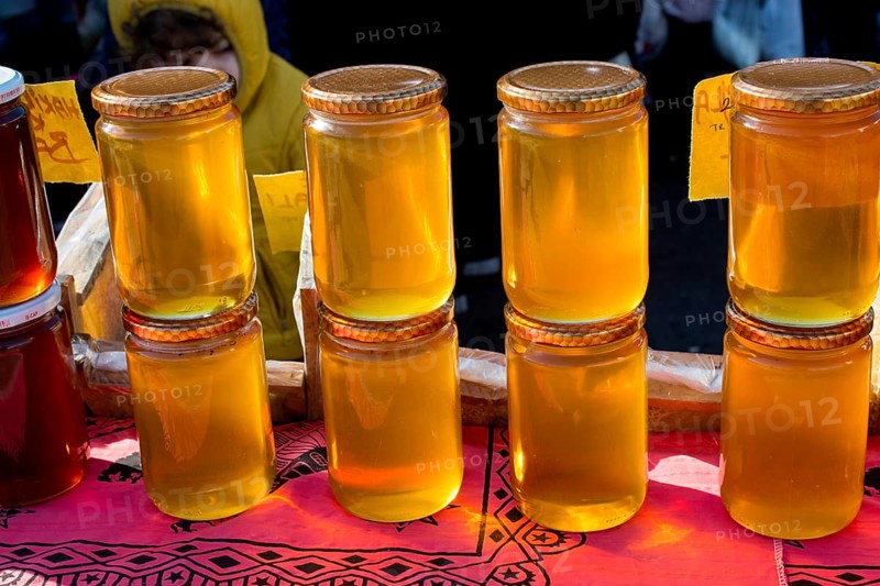 Glass jar of full of fresh honey with lid