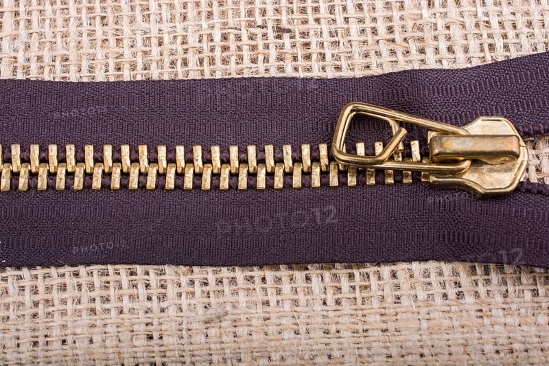 Closeup of a colorful zipper on linen canvas
