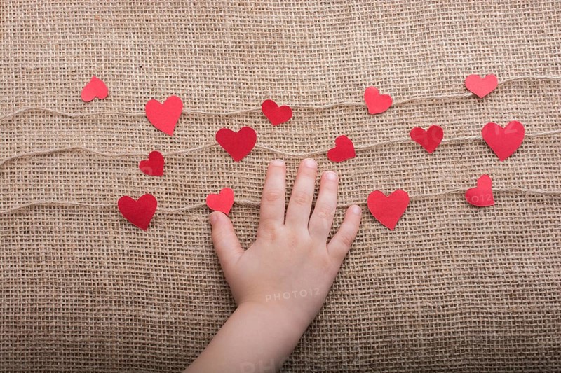 Love concept with heart shaped papers on linen threads