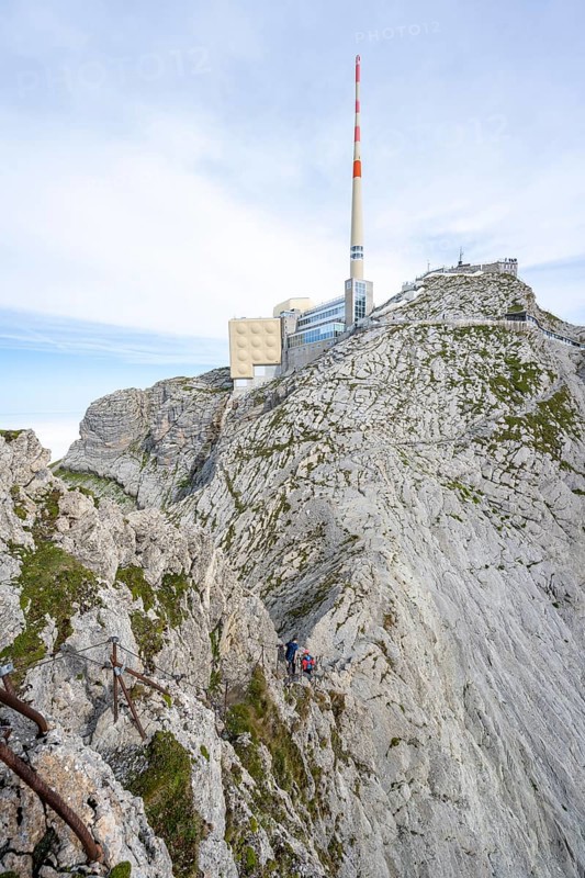 Climbers on a narrow ridge path