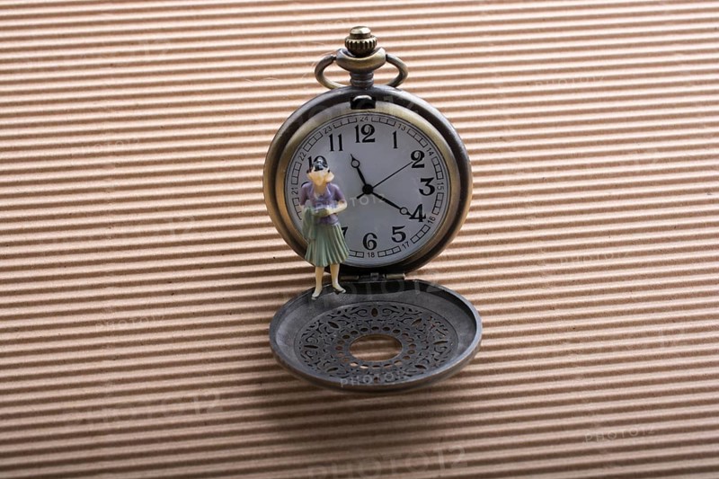 Paper woman shape and a retro pocket watch