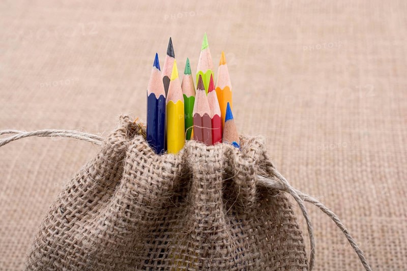 Color Pencils in a linen sack on canvas