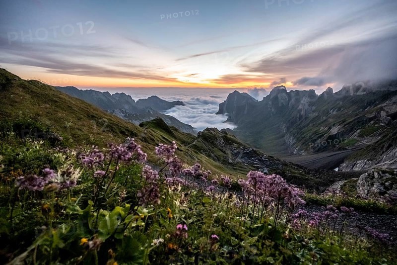 View over Saentis mountains into the valley of Meglisalp at sunrise