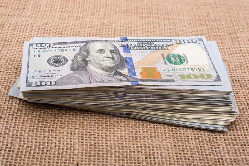 Banknote bundle of US dollar placed on a linen canvas
