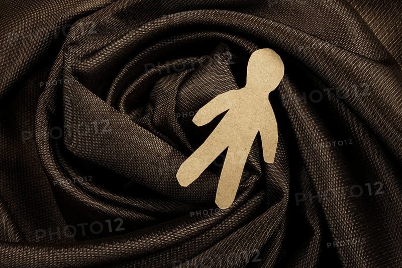 Man shape cut out of paper in hand in the view