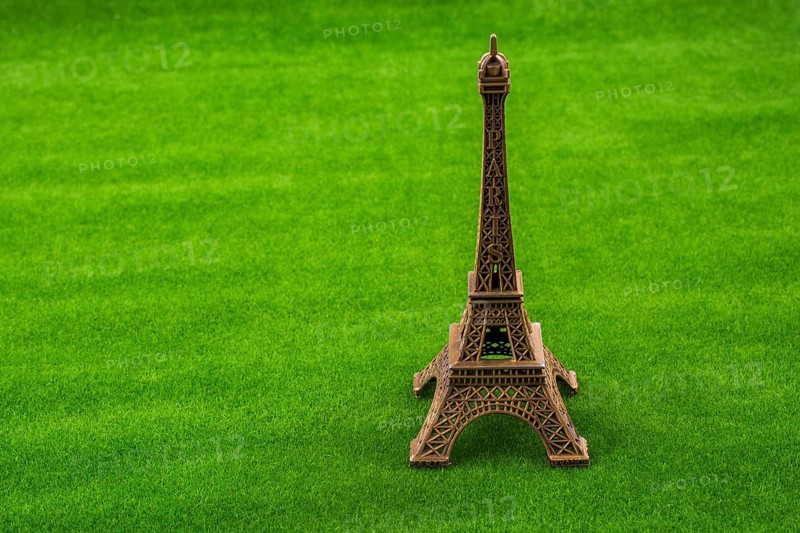 Little Eiffel Tower model on green grass
