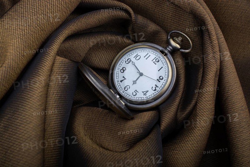 Mechanical retro styled pocket watch on fabric