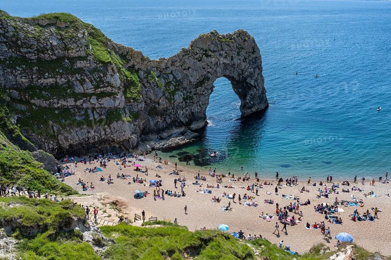 Bathing beach at the famous rock bridge Durdledoor