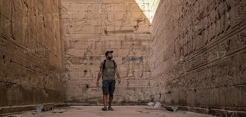 A young tourist visiting the beautiful temple of Edfu in the city of Edfu