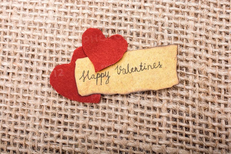 Love icon and Valentine's day wording on torn paper