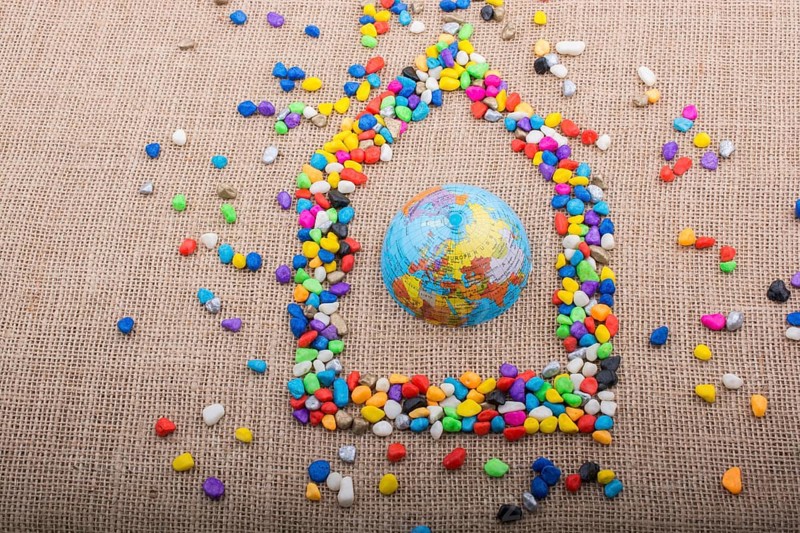 Globe in the house form shaped by colorful pebbles