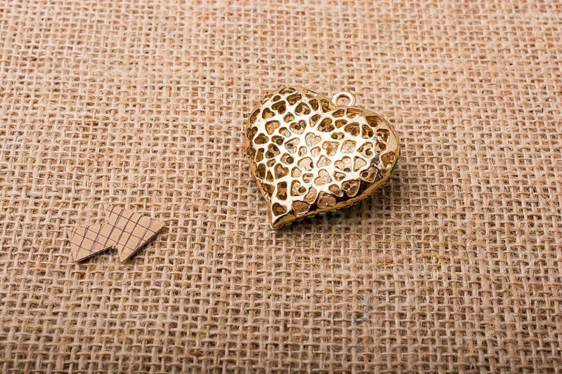 Heart shaped object with an arrow on canvas