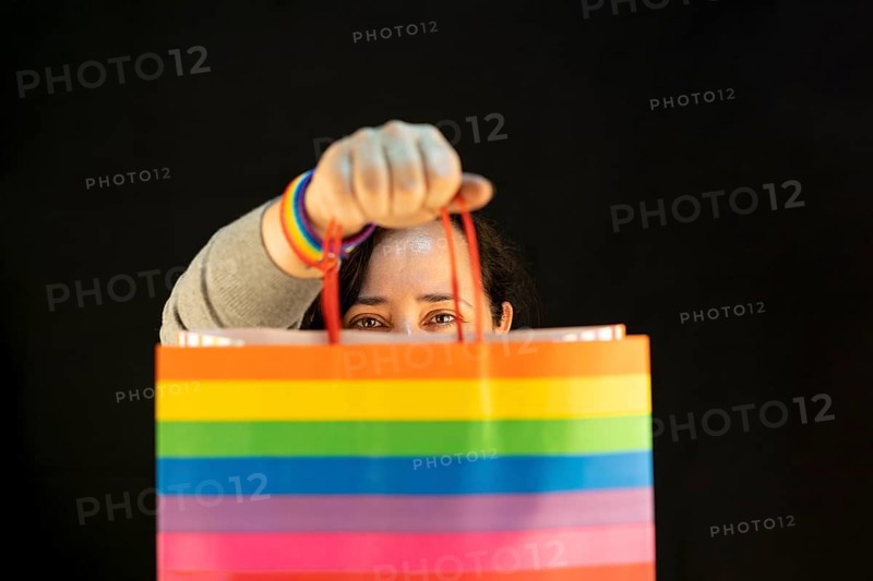 Woman holding lgbt bag. Joy of consumption. Purchases