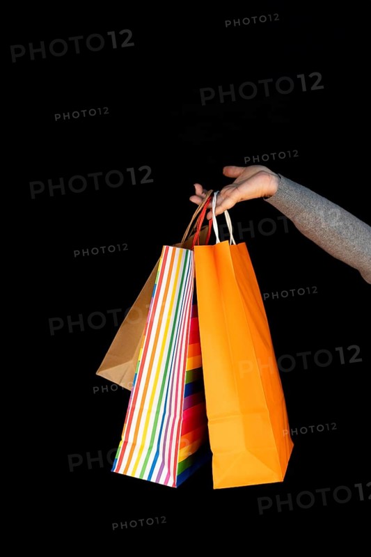 Shopping bags in the woman hands. Joy of consumption. Purchases