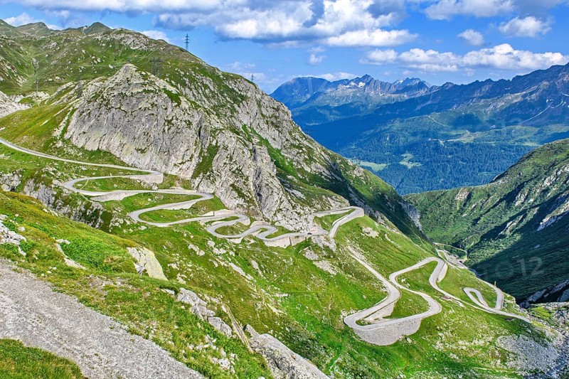 View from elevated position on old southern pass road Tremola south ramp with serpentines tight curves hairpin bends on steep mountain slope of Gotthard Pass