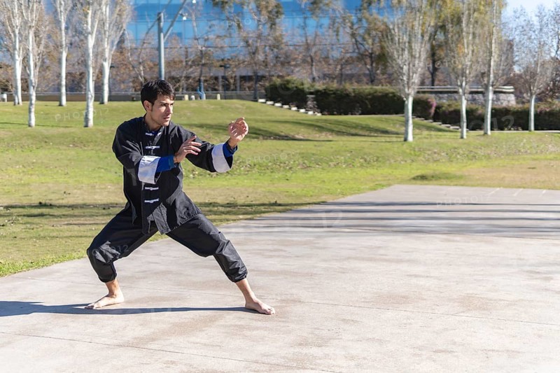 Young man practicing Kung Fu in the park