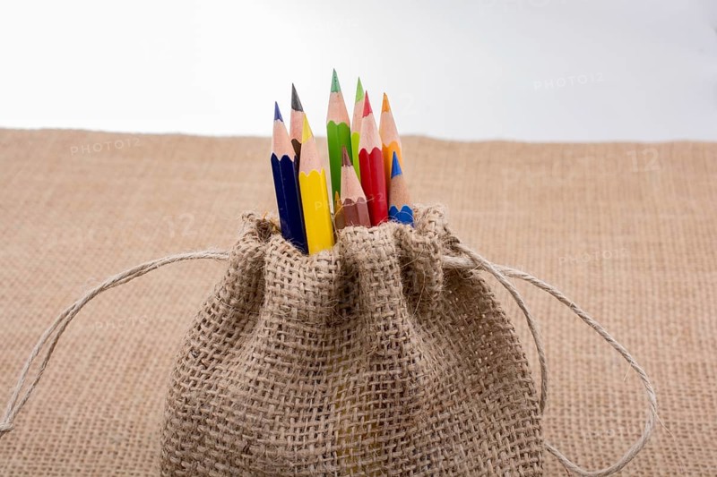 Color Pencils in a linen sack on canvas