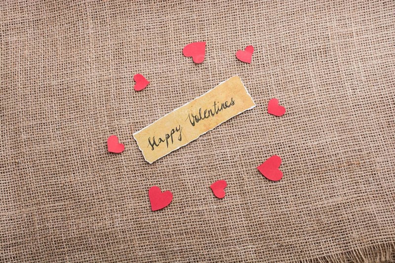 Love icon and Valentine's day wording on torn paper