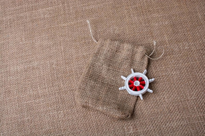 Steering wheel of a boat on a sack on canvas