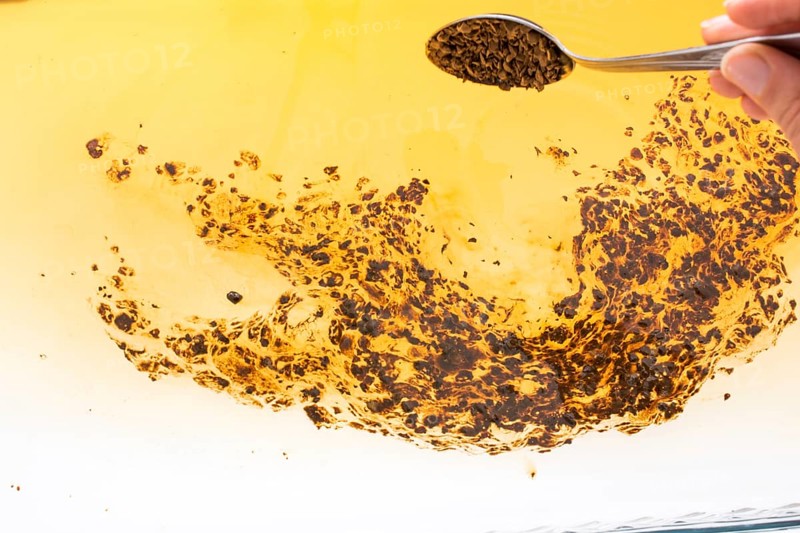 Coffe slowly dissolve in the hot water