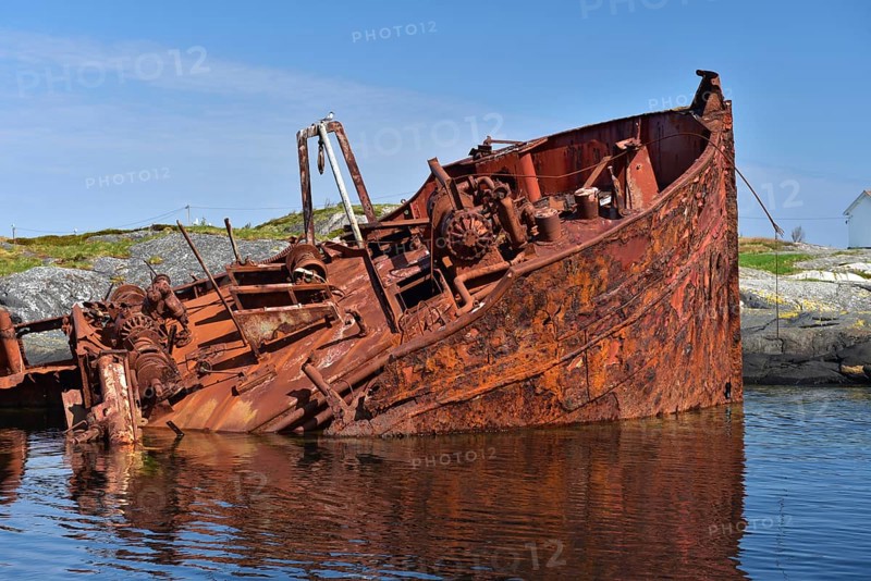Rusty shipwreck on the Atlantic Strait in Norway