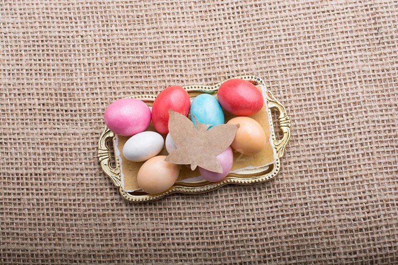 Paper Butterfly on Colorful candy sweets in tray