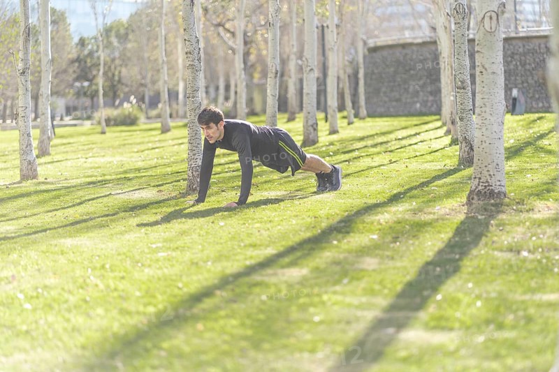 Man doing push ups in the park