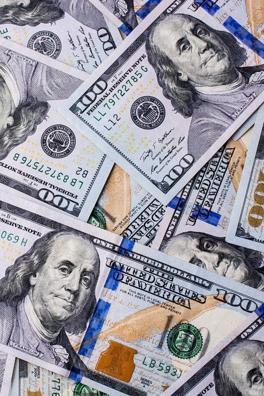 American 100 dollar banknotes made of paper placed on white background