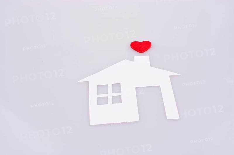 White paper house with a small red heart