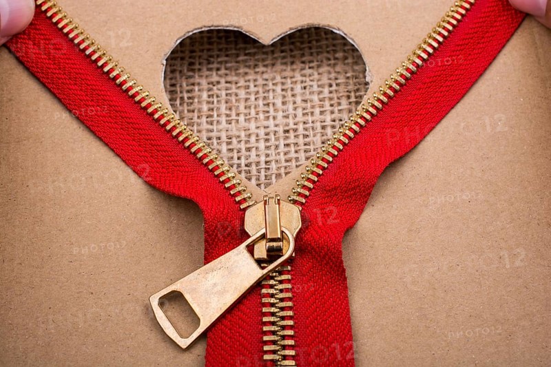 Zipper and heart shape hole on paper
