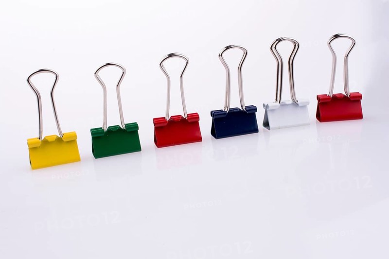 Colored paper clips on a white background