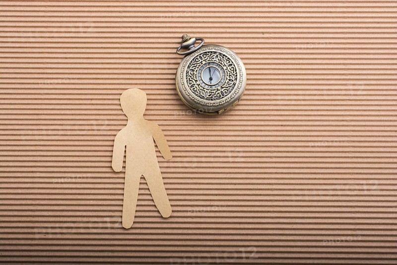 Paper man shape and a retro pocket watch