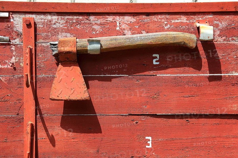 Red axe on red background