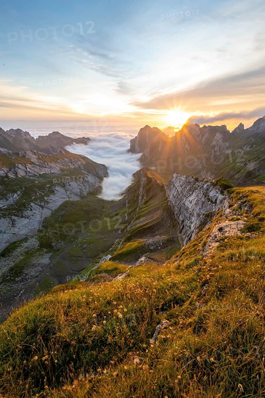 View over Saentis mountains into the valley of Meglisalp at sunrise