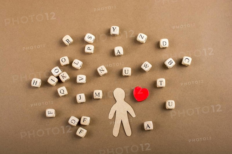 Letter cubes of made of wood and man figurine and heart shape