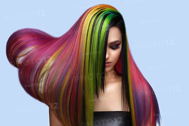 Portrait of beautiful woman with multi-colored hair and creative make up and hairstyle