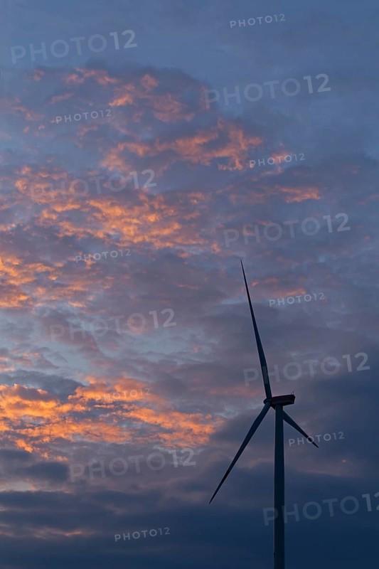 Wind power plant in front of evening sky