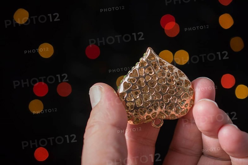 Heart shape icon in hand on bokeh light