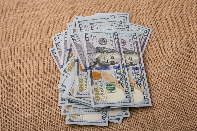 Banknote bundle of US dollar placed on a linen canvas