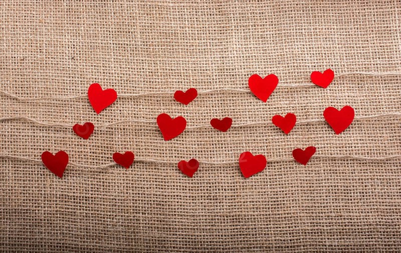 Love concept with heart shaped papers on linen threads