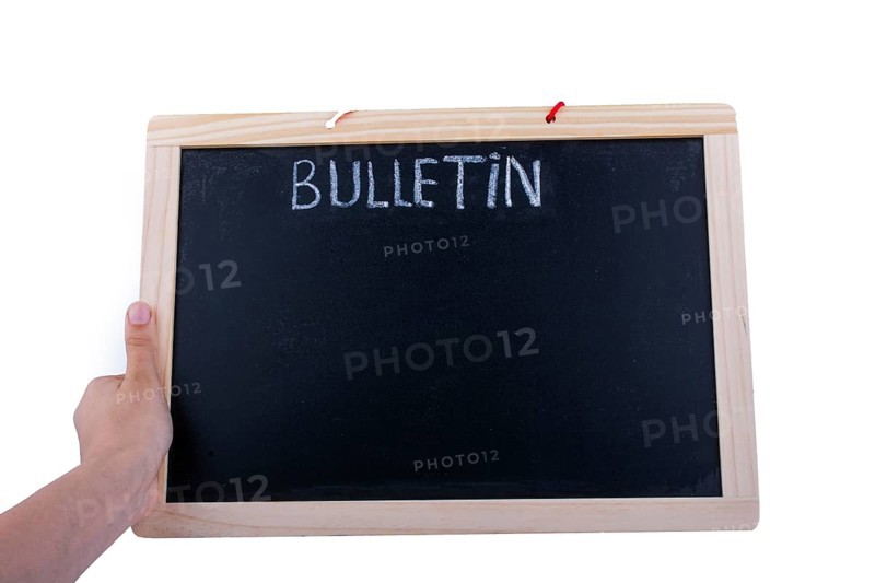 Hand holding the board with the title of bulletin