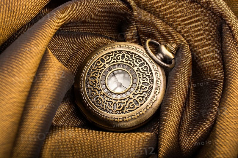 Mechanical retro styled pocket watch on fabric