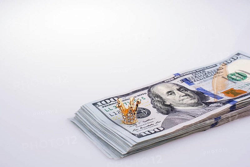 American 100 dollar banknotes and a gold color crown