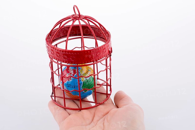 Small globe trapped in a red birdcage