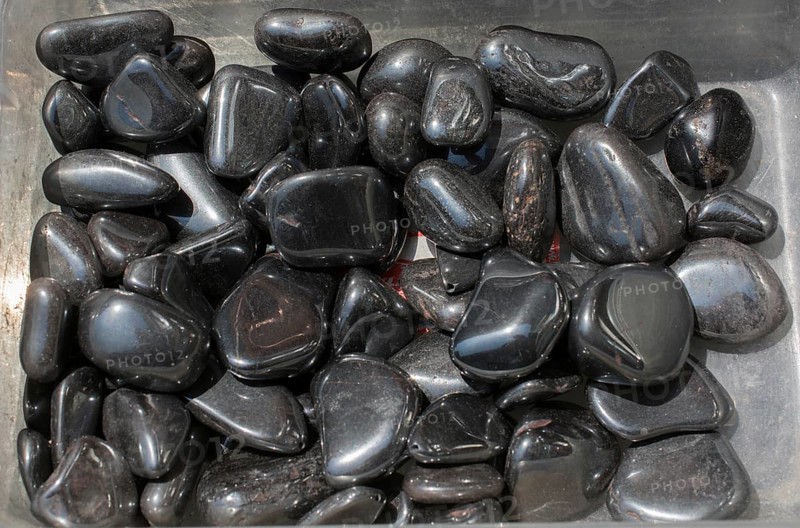 Shiny metallic gray tumbled hematite gemstone as mineral rock
