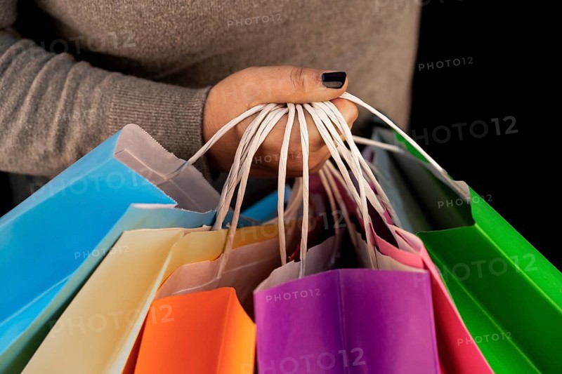 Shopping bags in the woman hands. Joy of consumption. Purchases
