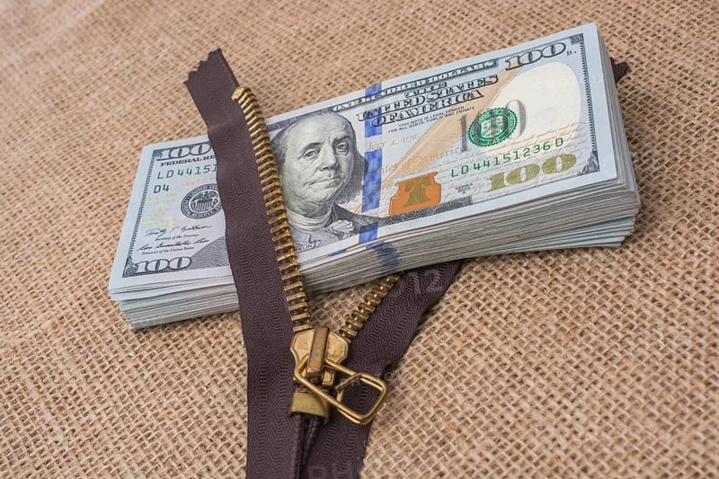 Banknote bundle of US dollar and a brown zipper