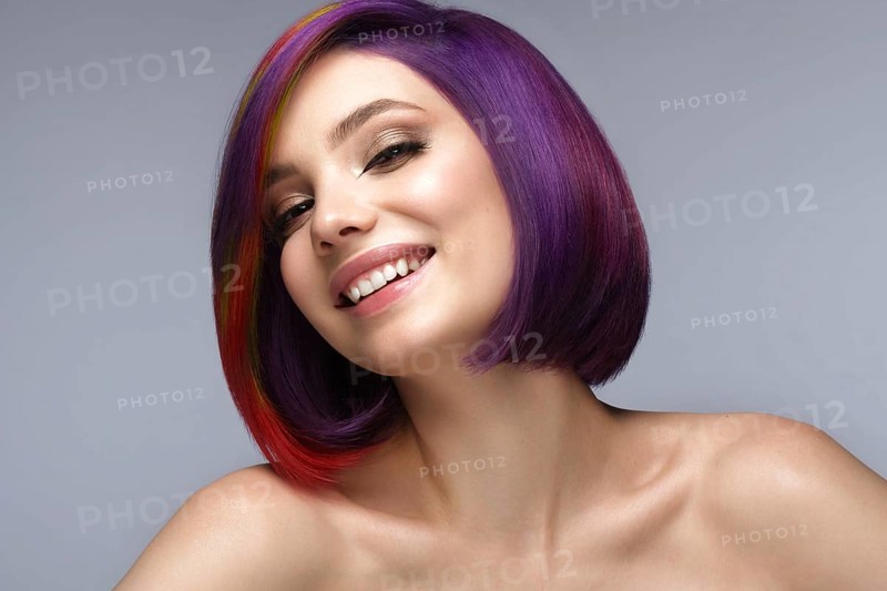 Portrait of beautiful woman with multi-colored hair and creative make up and hairstyle
