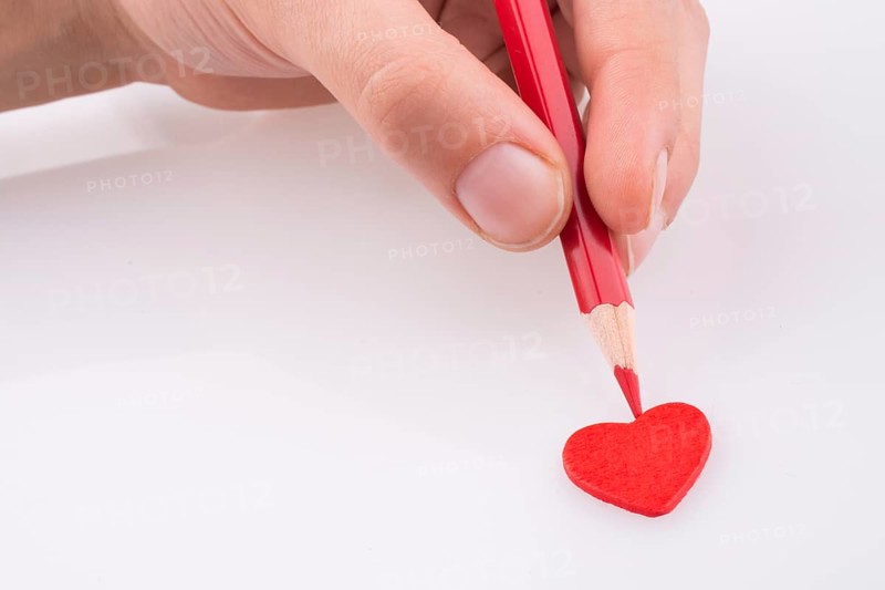 Pencil pointing a red heart