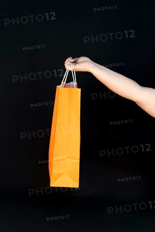 Shopping bag in the woman hands. Joy of consumption. Purchases